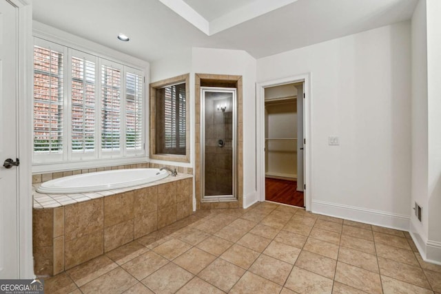 bathroom featuring tile patterned flooring and independent shower and bath