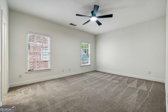 carpeted empty room featuring ceiling fan