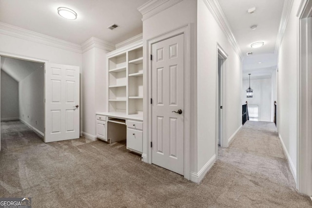 corridor featuring crown molding and light colored carpet