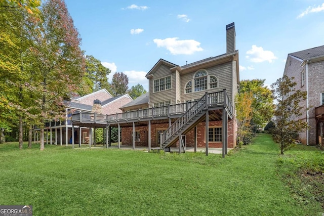 back of property with a yard and a wooden deck