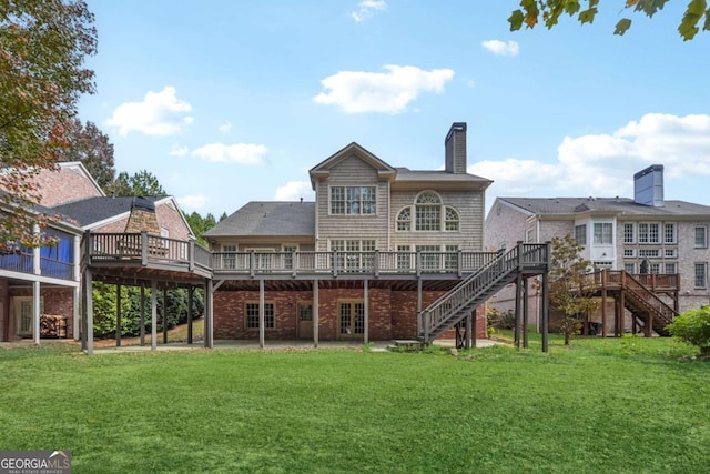 rear view of property with a lawn and a wooden deck