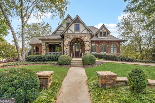 tudor-style house with a front lawn