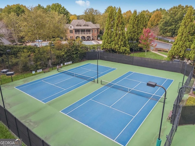 view of tennis court with basketball hoop