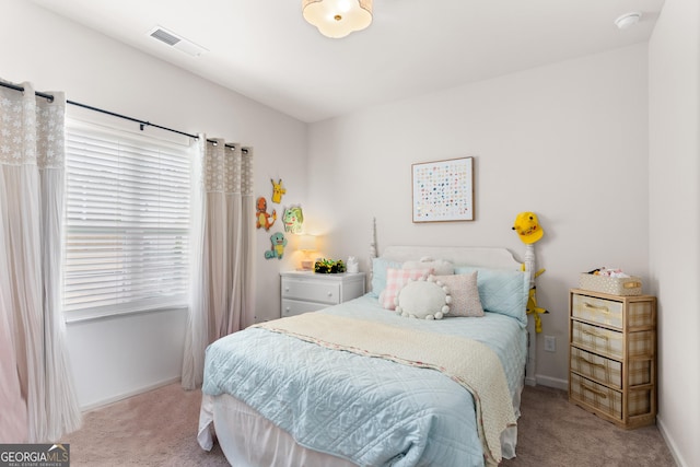 bedroom with light carpet and multiple windows