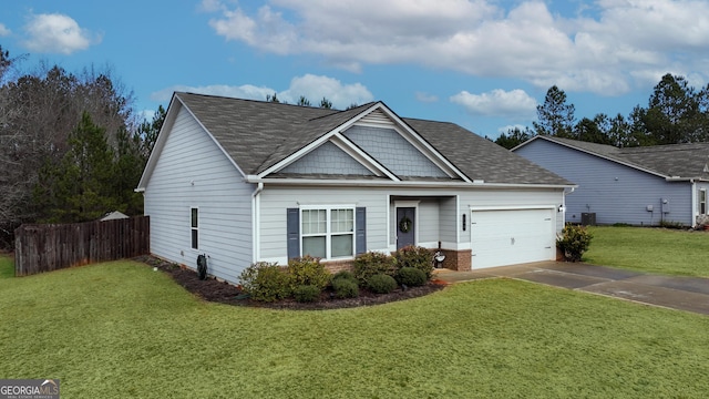 view of front of property featuring cooling unit, a front yard, and a garage