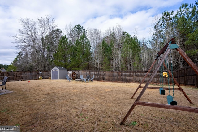 view of yard featuring a playground and a shed