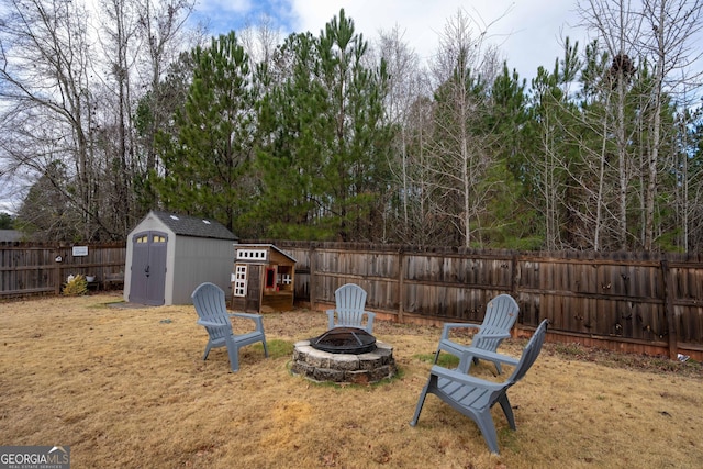 view of yard featuring a shed and a fire pit