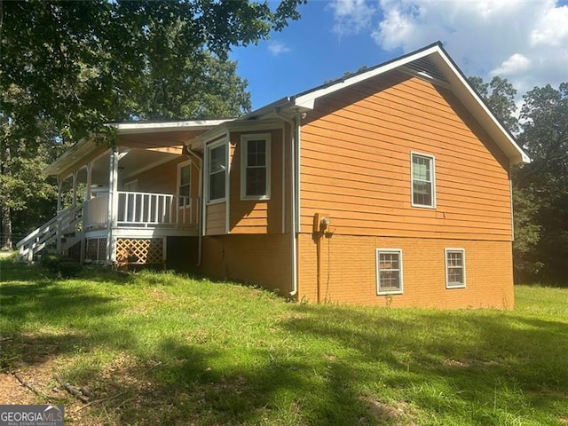 view of property exterior featuring covered porch and a yard