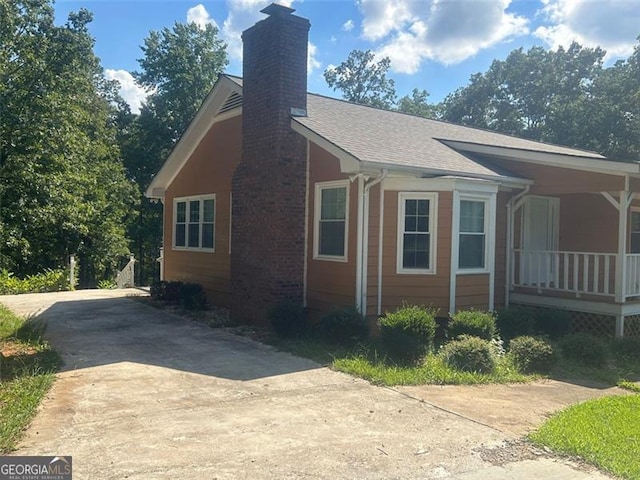 view of side of home with a porch