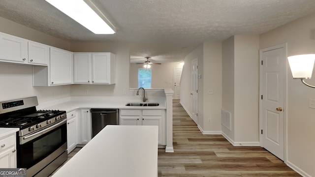 kitchen featuring white cabinets, ceiling fan, sink, and stainless steel appliances