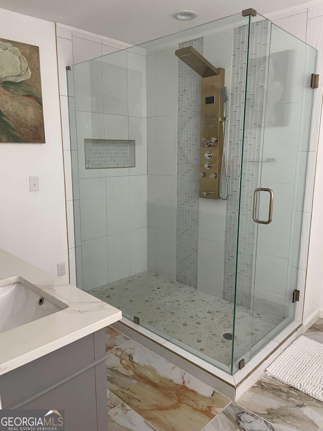 bathroom featuring vanity and a shower with door