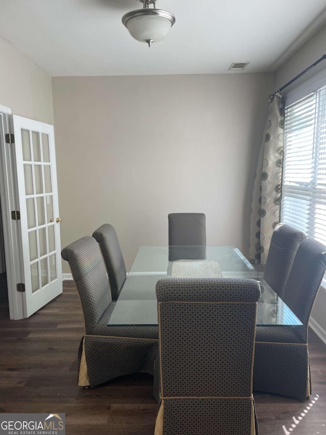 dining room with dark hardwood / wood-style flooring