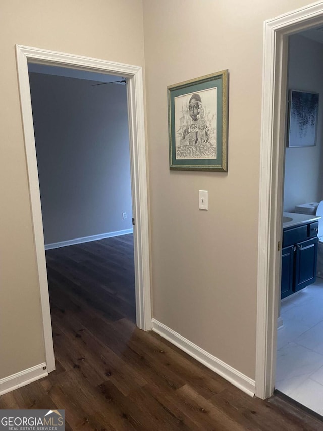 corridor with dark hardwood / wood-style flooring