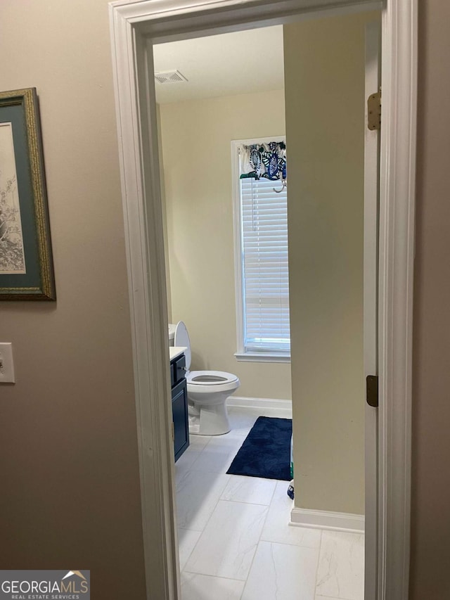 bathroom with vanity and toilet