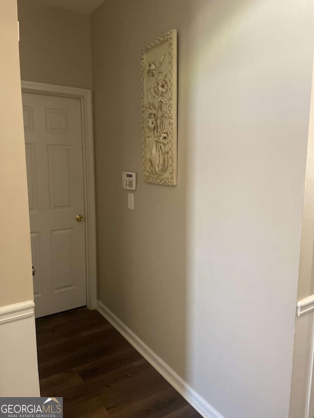 hallway featuring dark hardwood / wood-style flooring