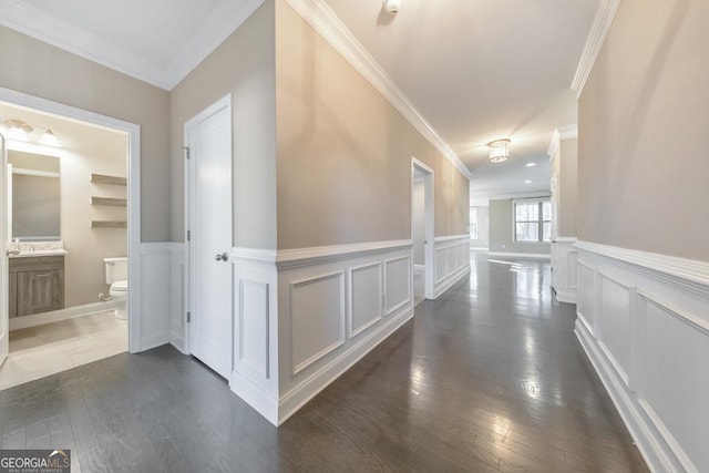 hallway with crown molding and dark wood-type flooring