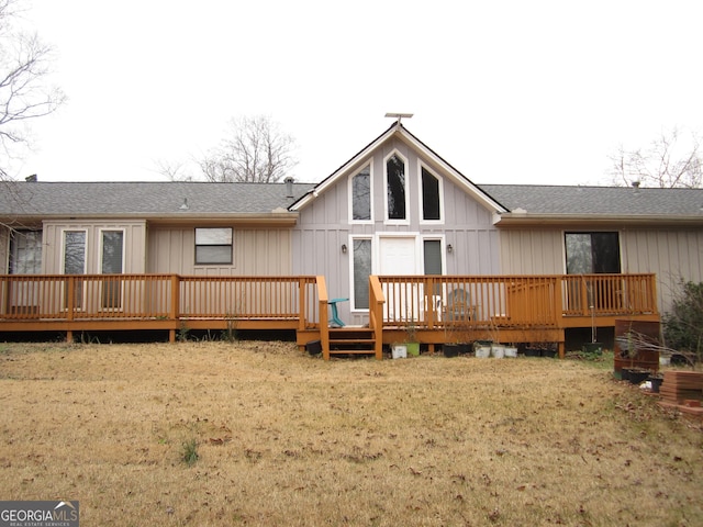 rear view of house with a lawn and a deck