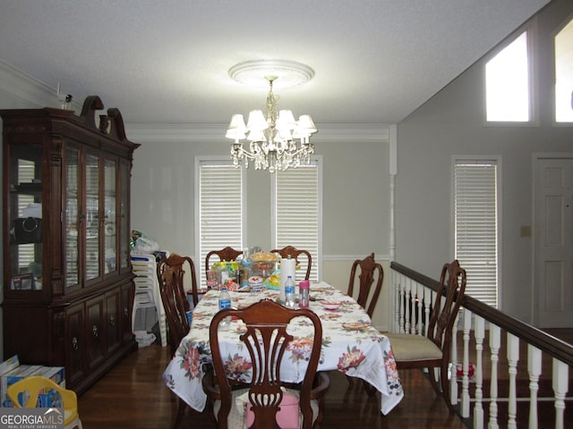 dining room featuring dark hardwood / wood-style flooring, crown molding, and a chandelier