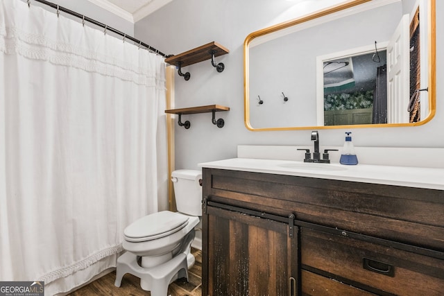 bathroom featuring wood-type flooring, vanity, toilet, and crown molding