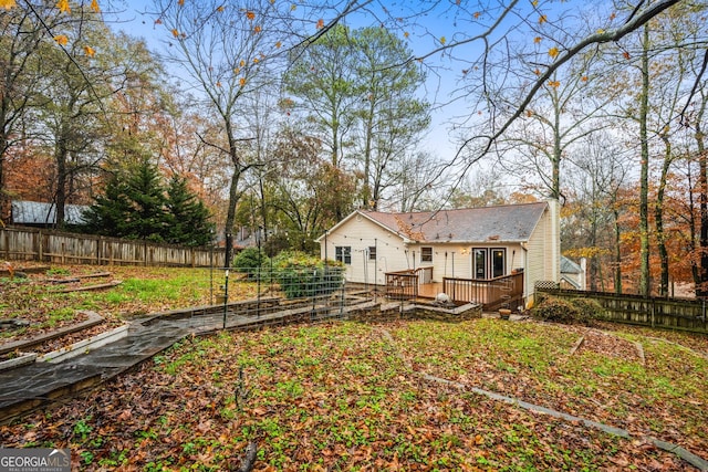 back of property featuring a wooden deck