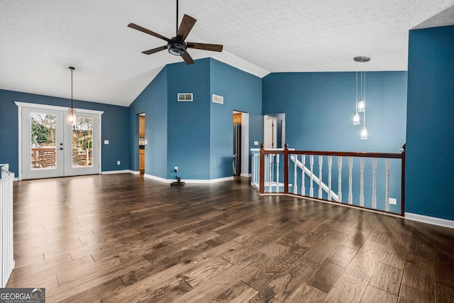 unfurnished living room featuring lofted ceiling, french doors, hardwood / wood-style flooring, ceiling fan, and a textured ceiling