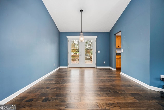 unfurnished dining area featuring french doors, dark hardwood / wood-style floors, and lofted ceiling