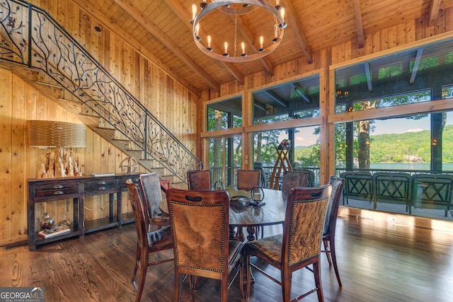 dining space featuring beam ceiling, dark hardwood / wood-style flooring, wooden ceiling, and a healthy amount of sunlight