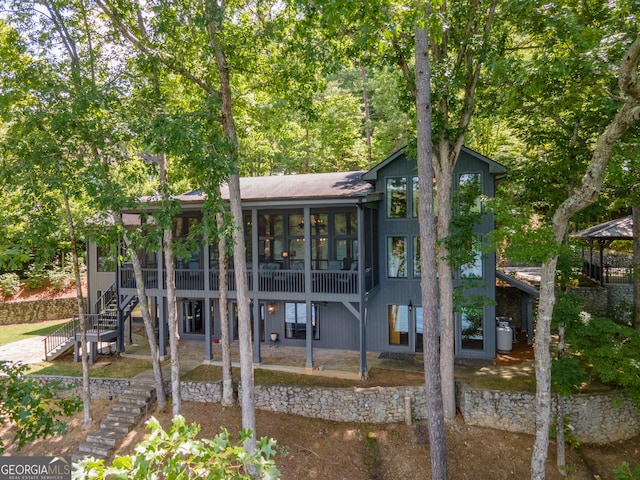 back of house featuring a sunroom