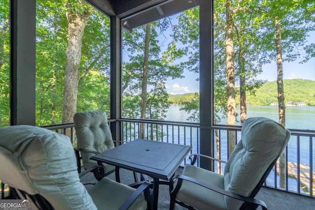 sunroom / solarium with plenty of natural light and a water view