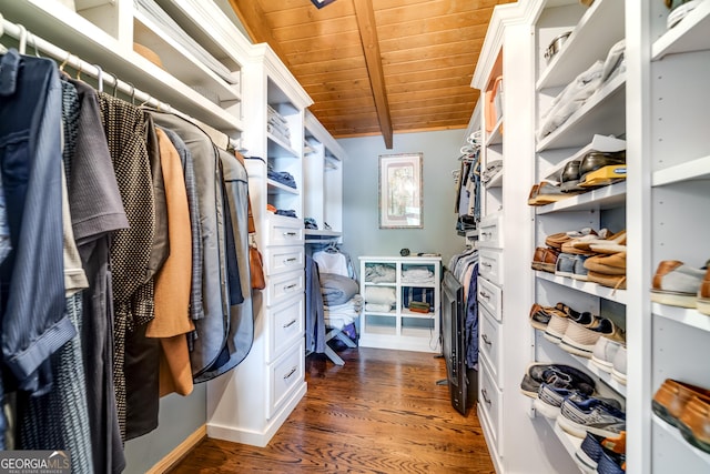 spacious closet with lofted ceiling with beams and dark hardwood / wood-style floors