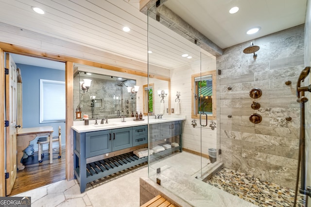 bathroom with vanity and a shower with shower door