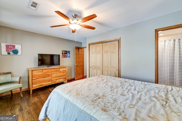 bedroom featuring ceiling fan, a closet, and dark hardwood / wood-style floors