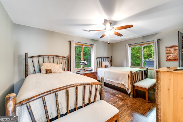 bedroom with ceiling fan and dark hardwood / wood-style flooring