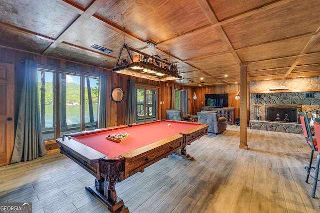 game room featuring hardwood / wood-style flooring, a stone fireplace, wooden ceiling, and billiards