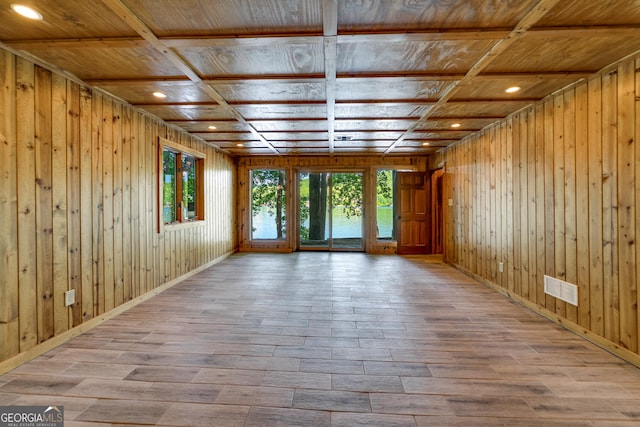 unfurnished room with plenty of natural light, wood ceiling, and coffered ceiling