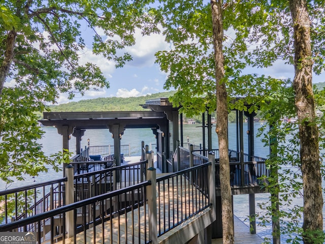 exterior space with a dock and a water view