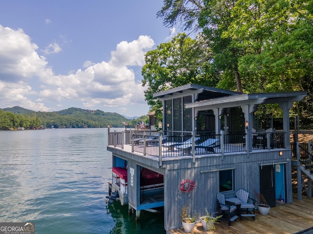 view of dock featuring a water and mountain view