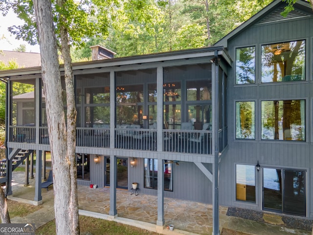 back of house featuring a sunroom and a patio area