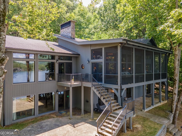 rear view of house featuring a patio and a sunroom