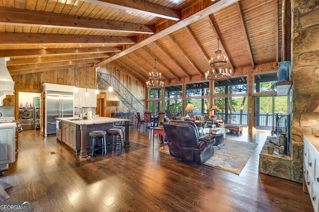 living room with high vaulted ceiling, dark hardwood / wood-style floors, beam ceiling, washer / dryer, and wood ceiling