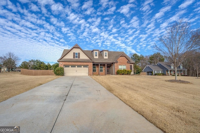 view of front of house featuring brick siding, concrete driveway, an attached garage, fence, and a front yard