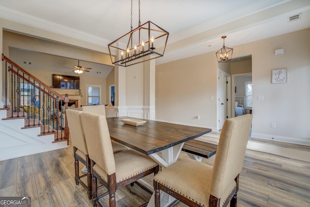 dining space featuring hardwood / wood-style flooring, ceiling fan, ornamental molding, and a healthy amount of sunlight