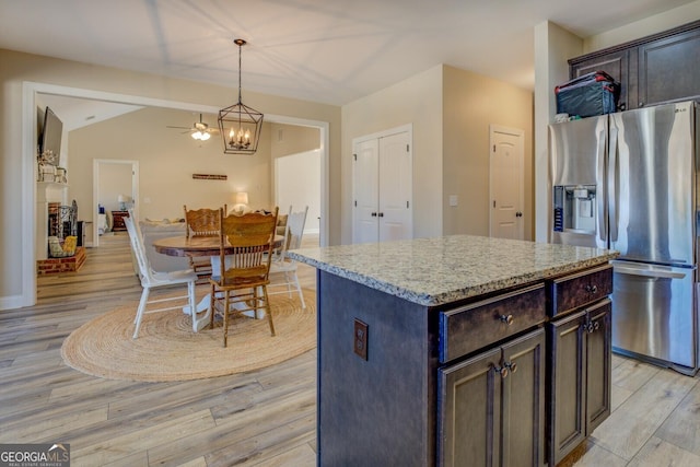 kitchen featuring hanging light fixtures, dark brown cabinets, a center island, and stainless steel refrigerator with ice dispenser