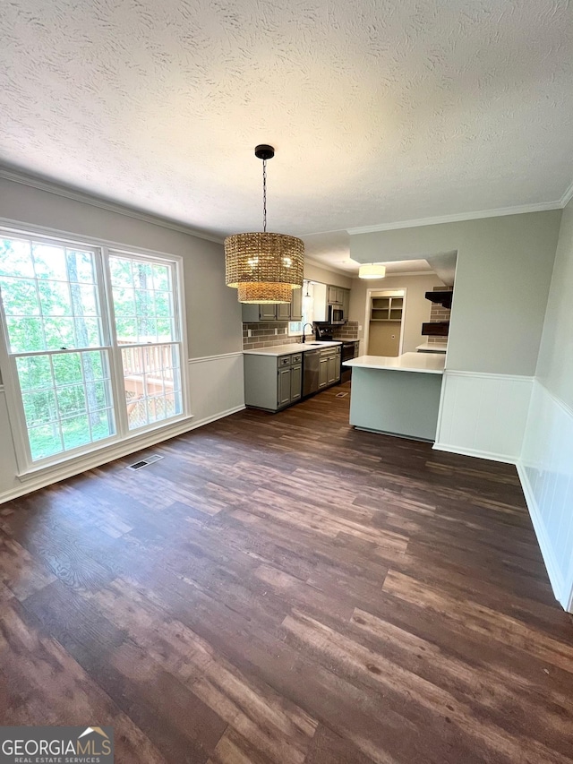 kitchen with a textured ceiling, dark hardwood / wood-style floors, sink, and hanging light fixtures