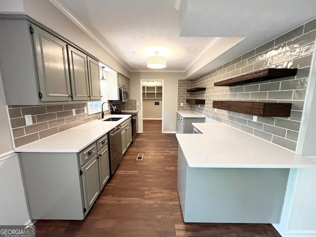 kitchen featuring light stone countertops, appliances with stainless steel finishes, tasteful backsplash, sink, and dark hardwood / wood-style floors