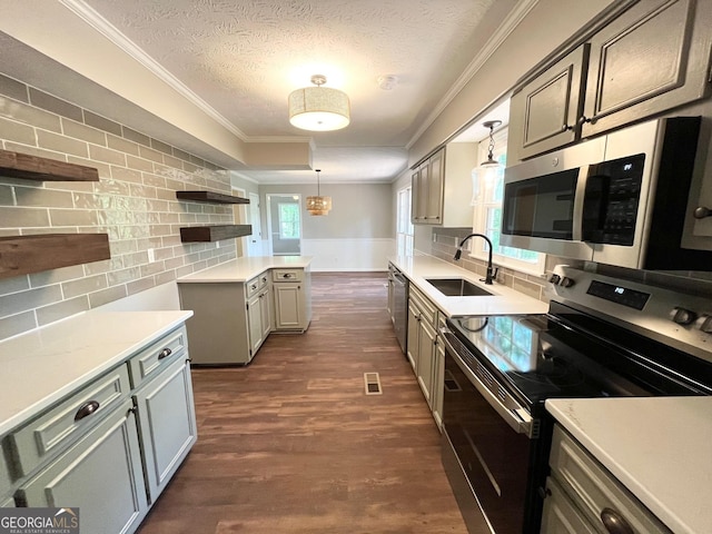 kitchen with backsplash, sink, a textured ceiling, decorative light fixtures, and stainless steel appliances