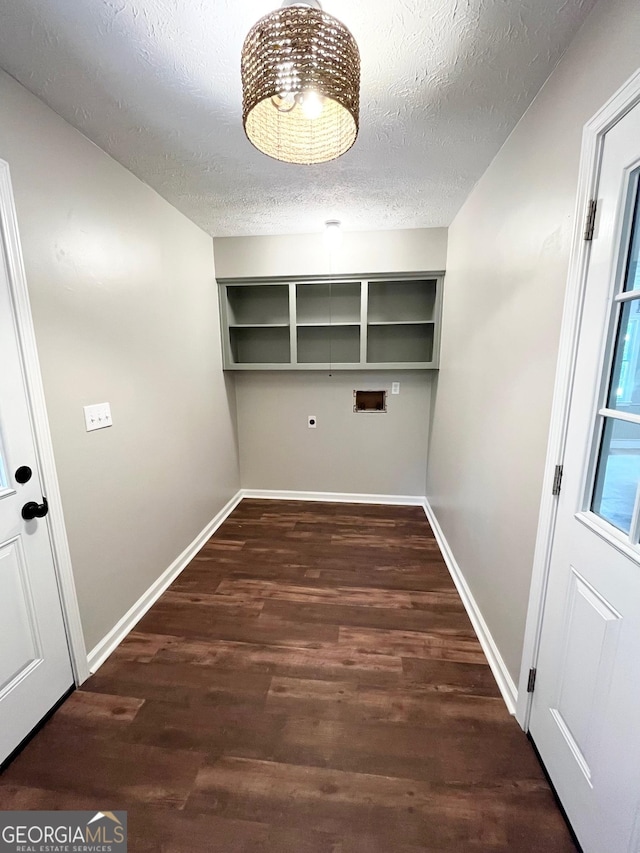 laundry area featuring dark hardwood / wood-style floors, a textured ceiling, and hookup for a washing machine