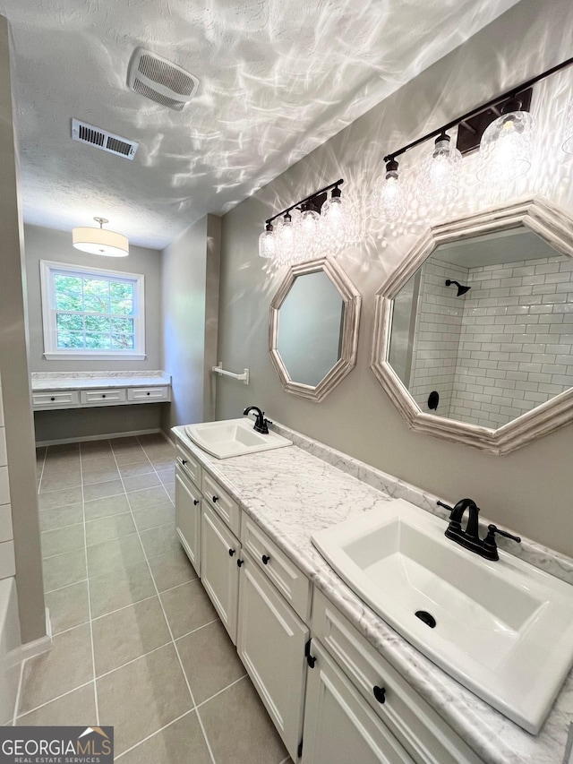 bathroom with tile patterned flooring and vanity