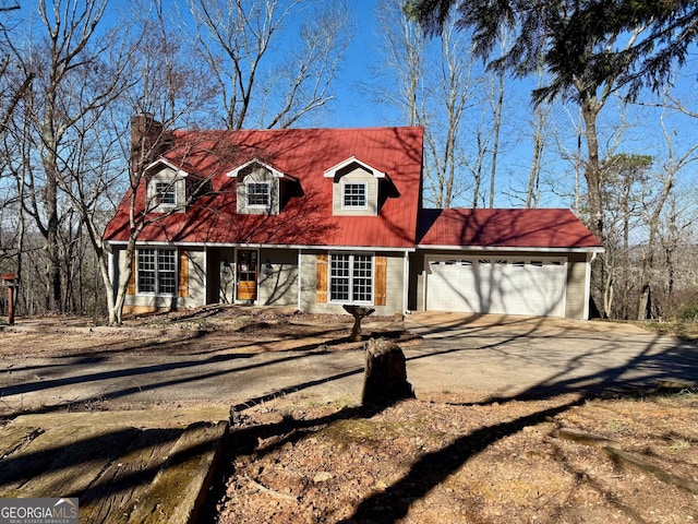 cape cod house featuring a garage