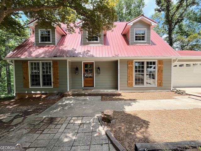 cape cod-style house with a porch and a garage